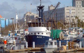 The A.C.E. fishing boat docked in a harbor.