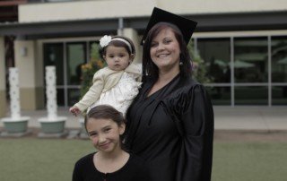 A woman and two children posing outside a building for Allyson’s Wild Ride.