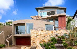 Modern coastal home with broad windows and a terrace in Laguna Beach.