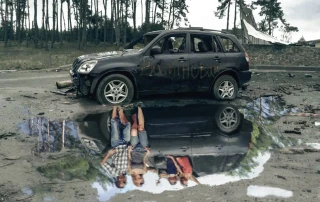 A damaged car near Kyiv reflected in a puddle.
